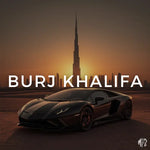 Black sports car in front of the Burj Khalifa at sunset.